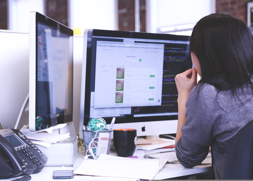 How to Turn Long-Form Content Into a Lead-Generating Digital Resource - Cube Creative Design | Digital Marketing image Woman working on a digital marketing project on a laptop
